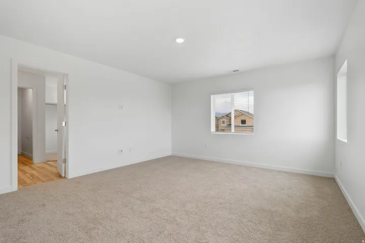 Neutral-toned carpeting with white wall paint