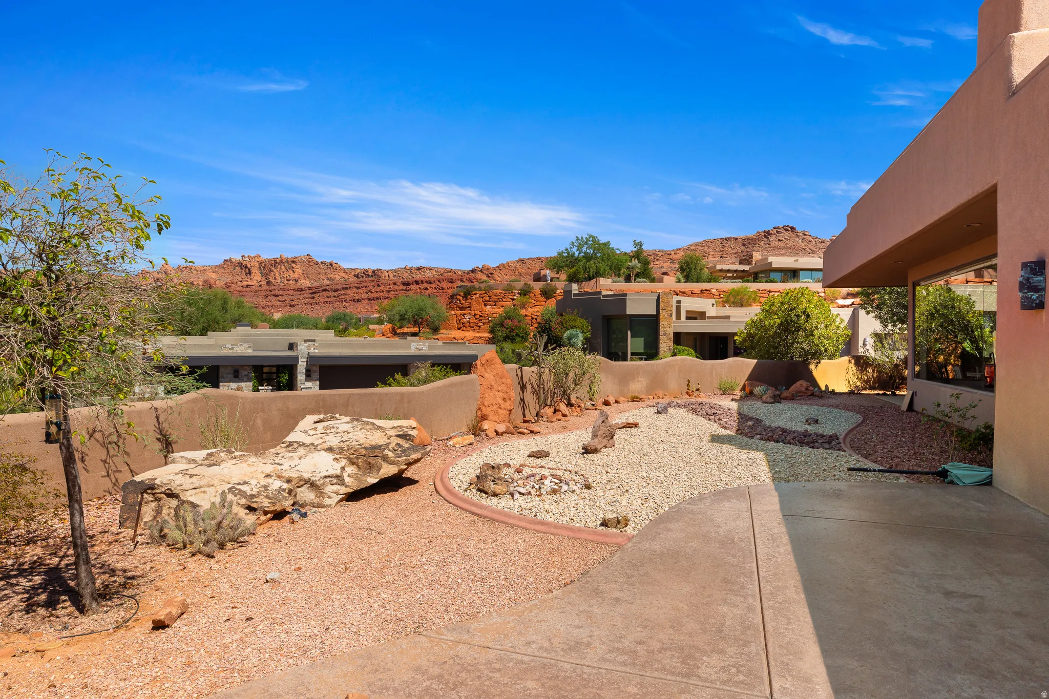 Desert-inspired landscaping with decorative gravel and natural rock formations