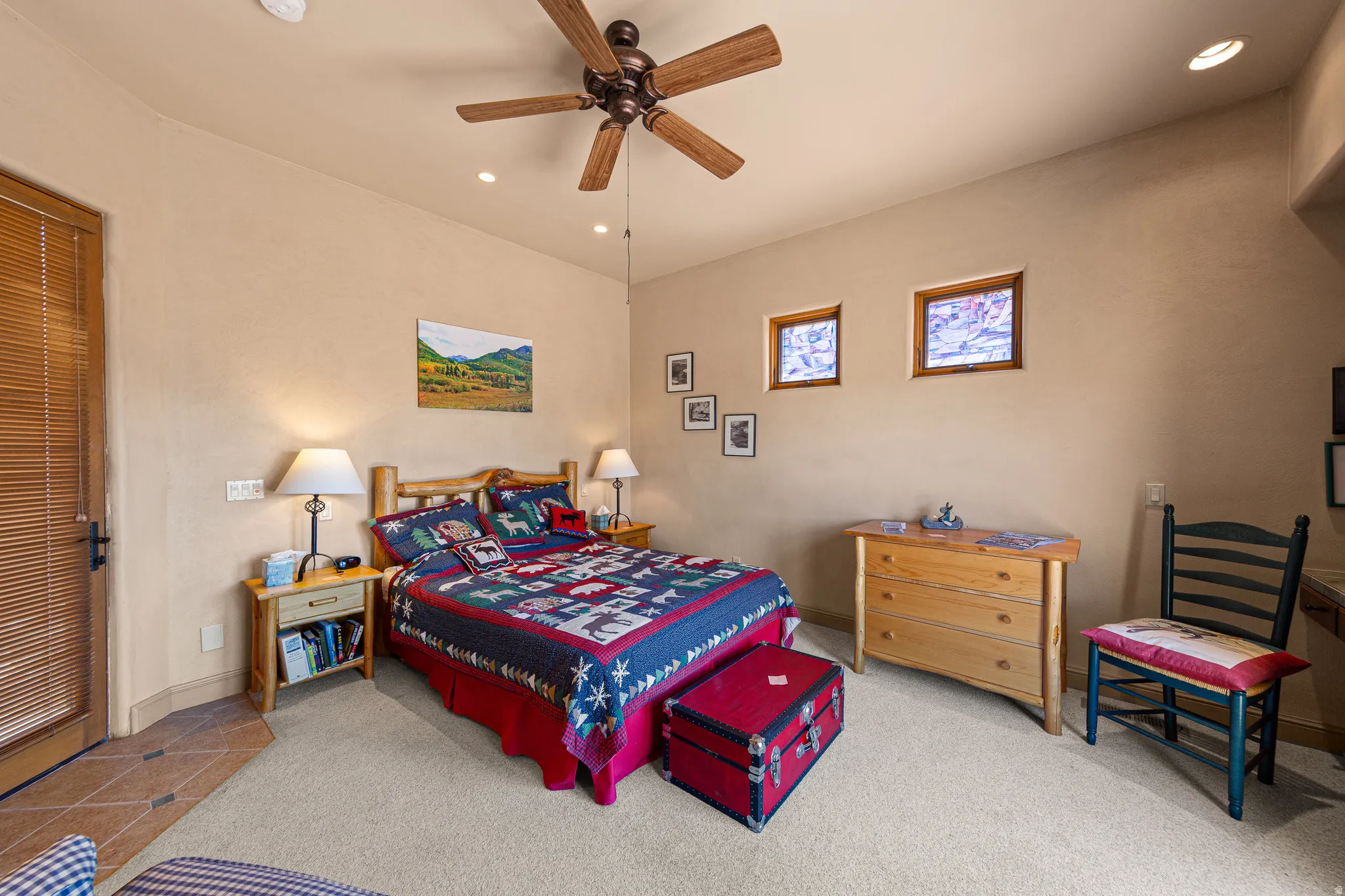 Recessed lighting, ceiling fan, and dual high windows provide illumination
