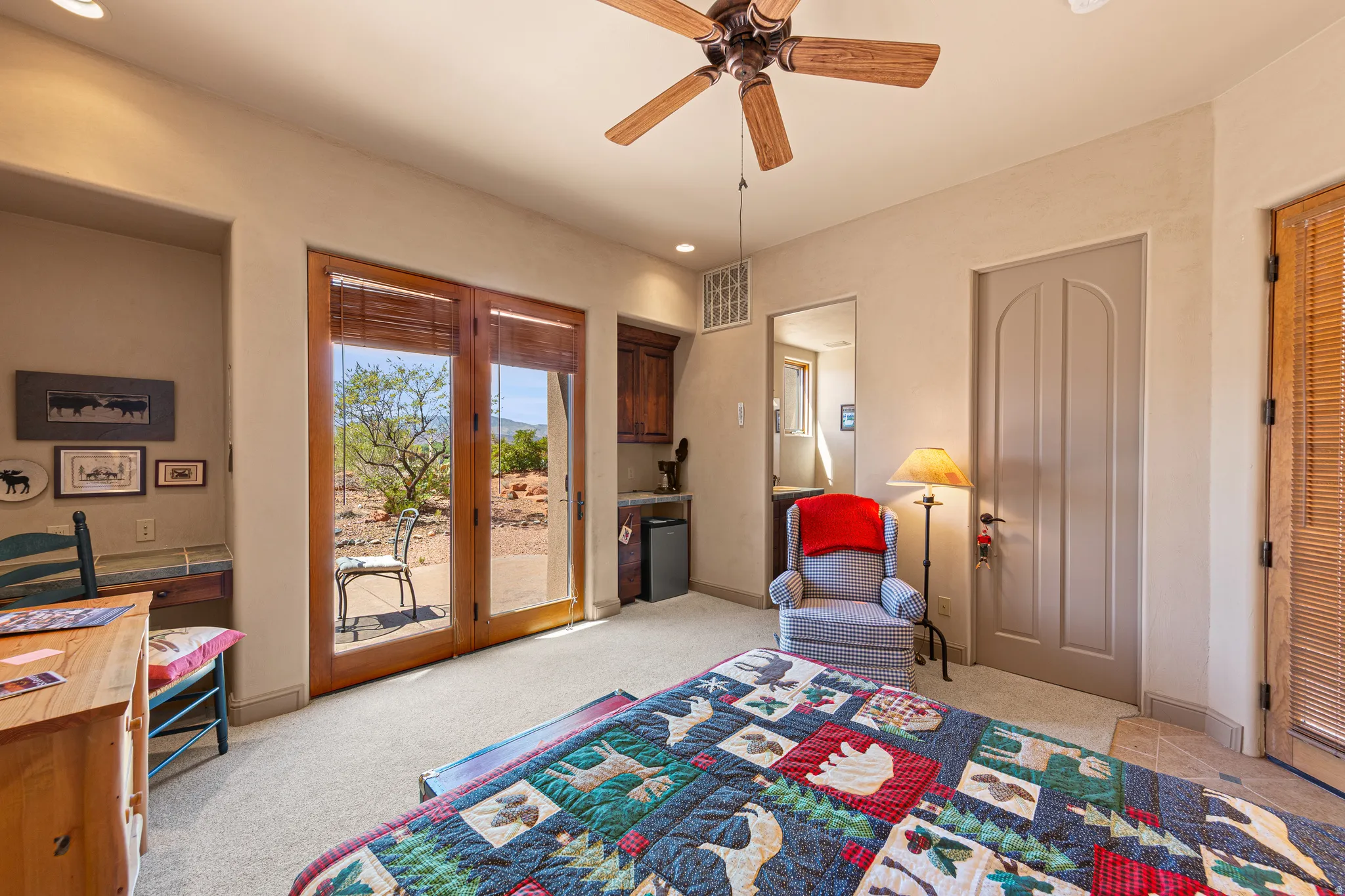 Carpeted room with a ceiling fan, recessed lighting, and a built-in wet bar featuring wood-finish cabinetry
