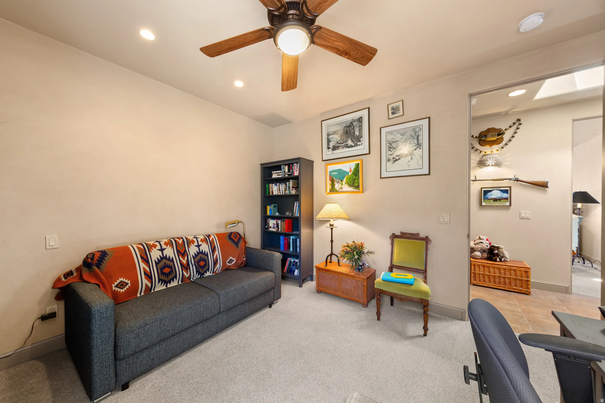 Recessed lighting, ceiling fan with light fixture, built-in shelving, light-colored walls, and carpeted flooring