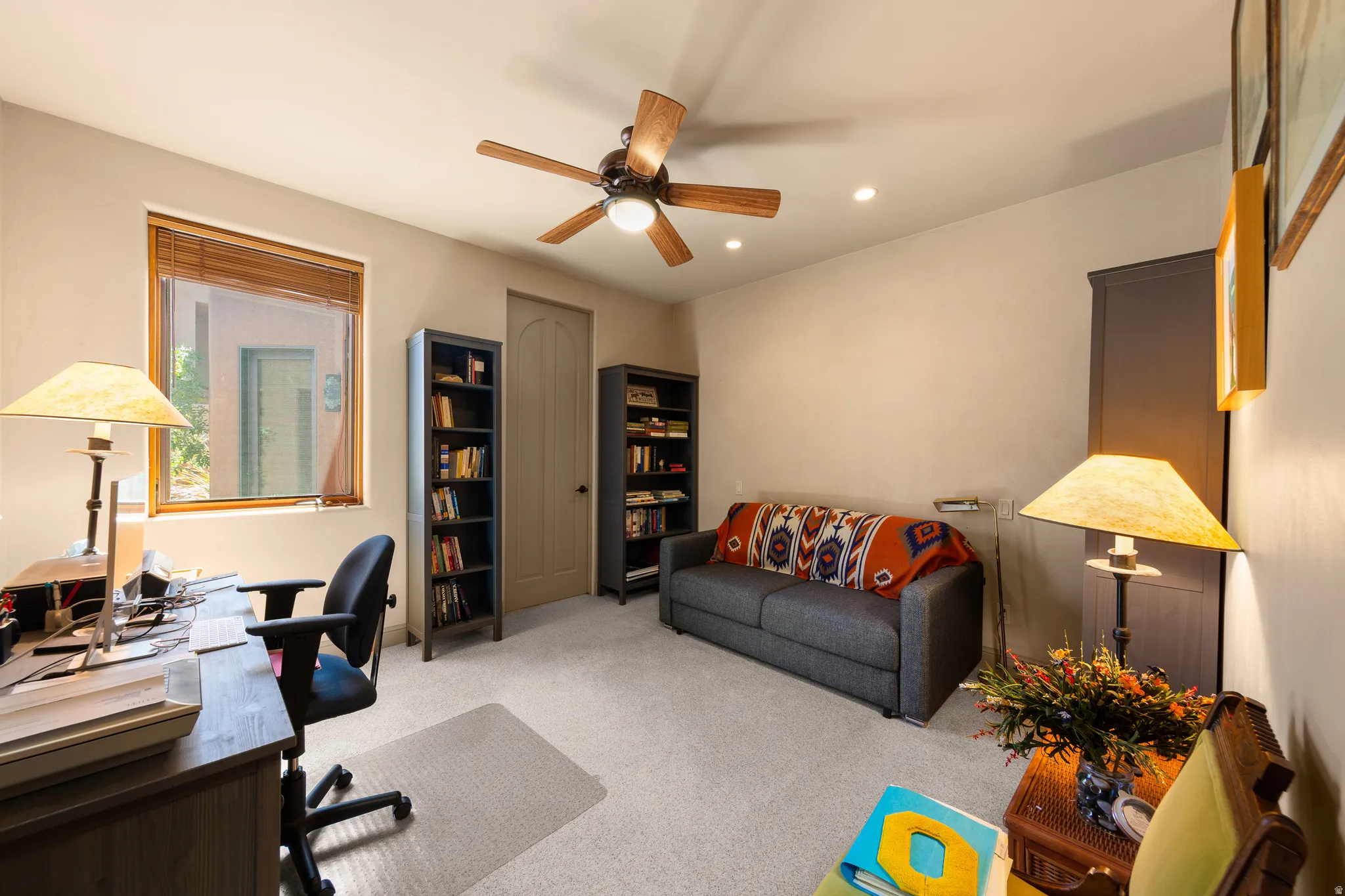 Carpeted room featuring a ceiling fan with light, recessed lighting, and a wood-framed window with blinds