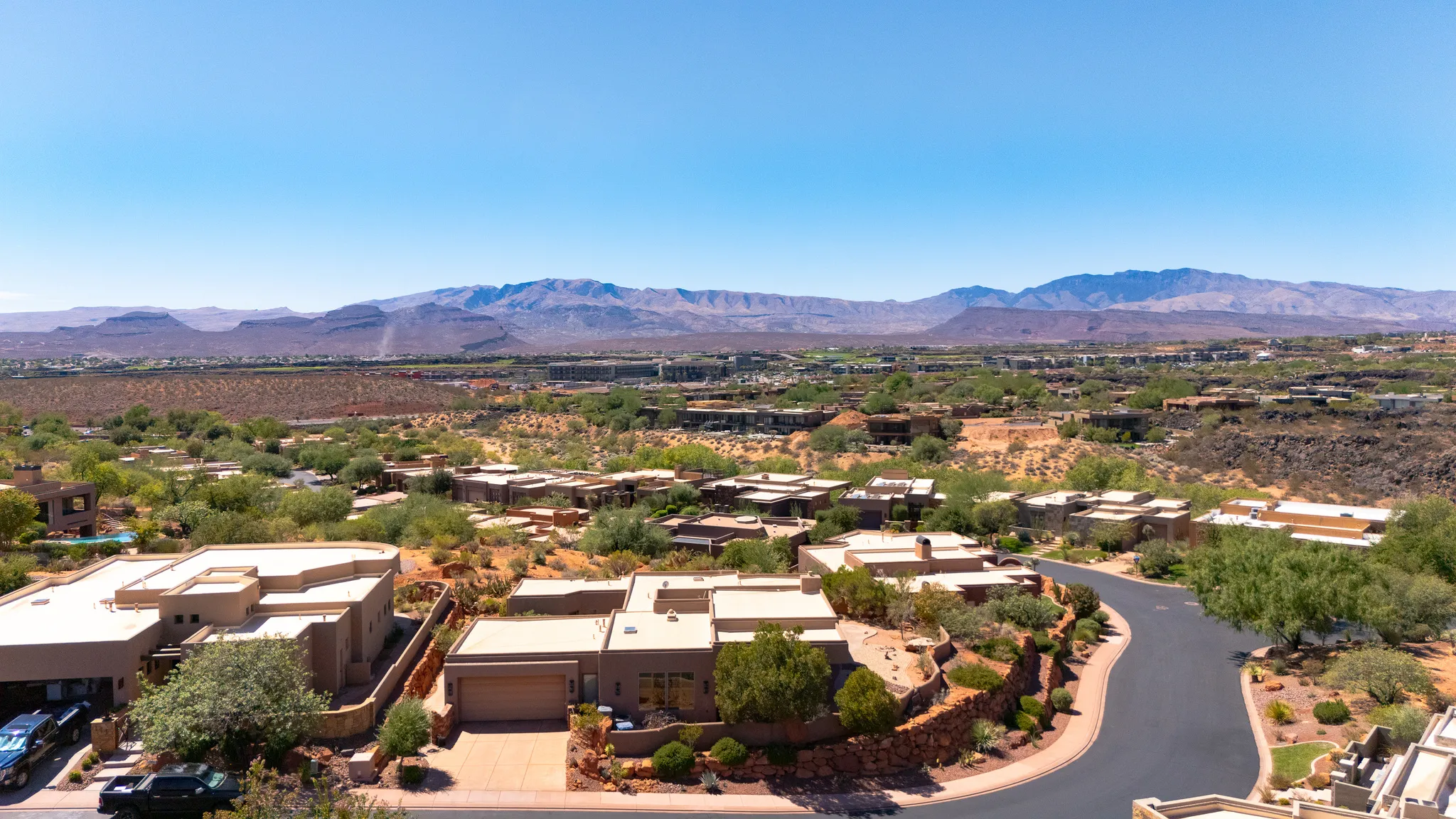 Desert landscape with residential properties and distant mountain range