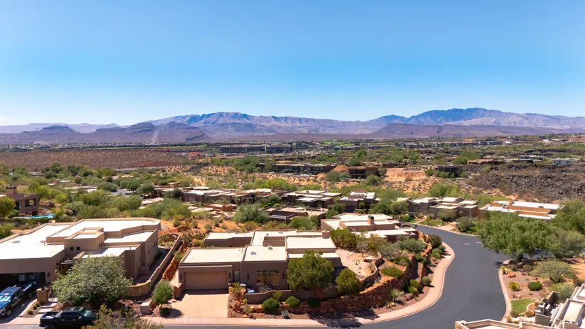 Desert landscape with residential properties and distant mountain range