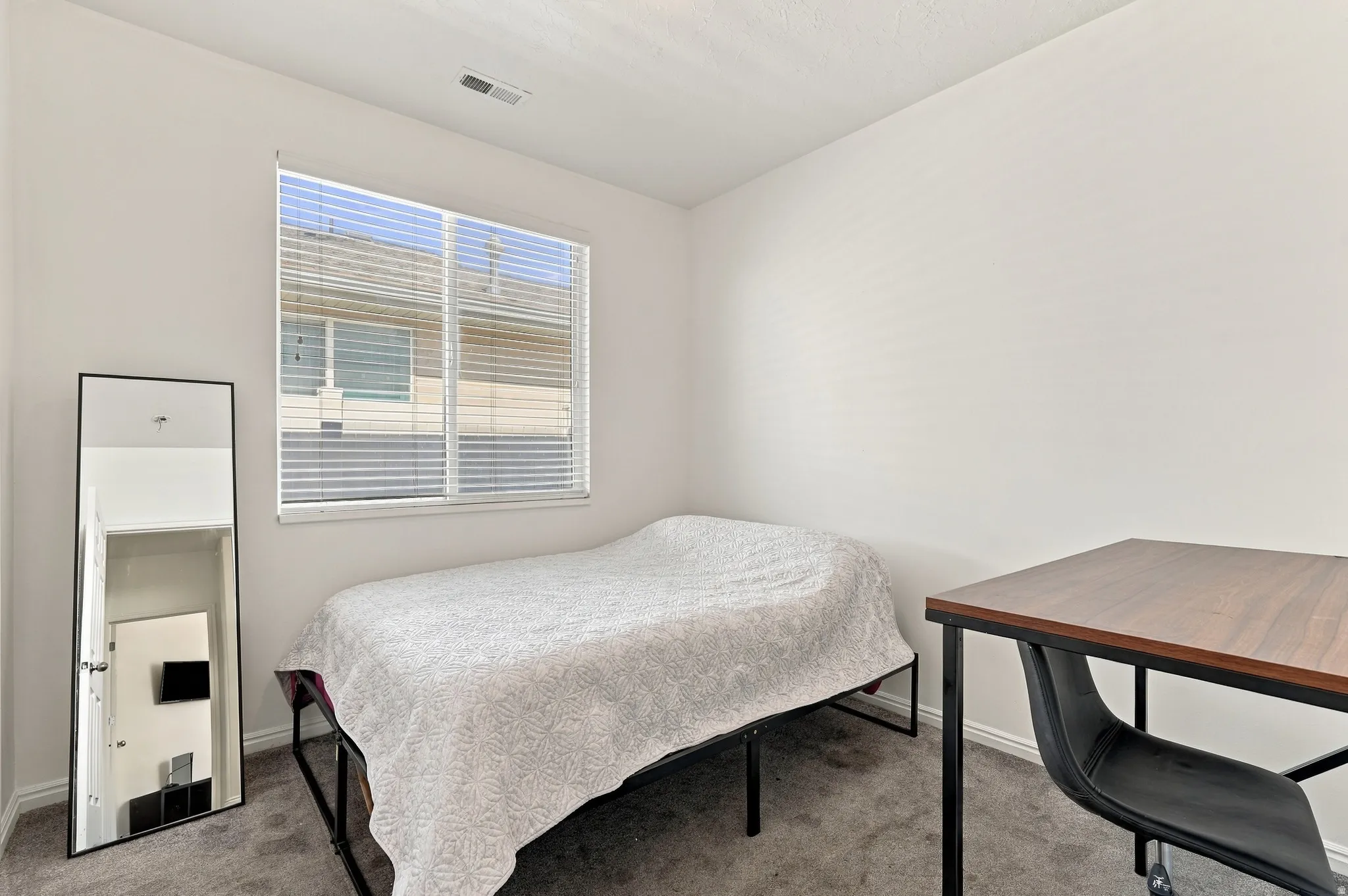 Neutral wall paint and carpeted flooring