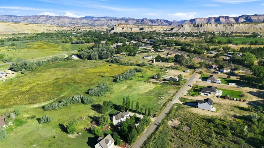 Expansive green landscapes with distant mountainous terrain under a clear sky