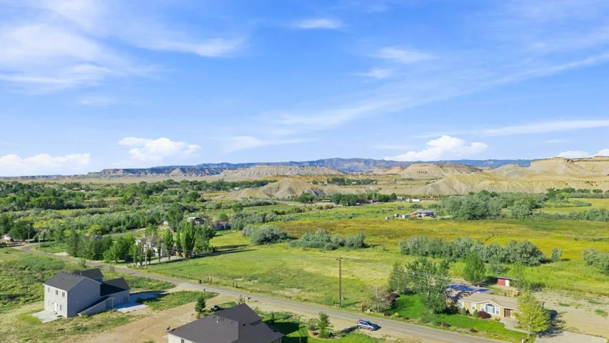 Expansive natural landscape with varied topography and distant mountainous terrain