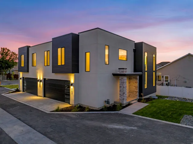 Modern exterior featuring contrasting dark paneling and light stucco
