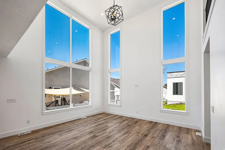 Soaring ceilings with expansive windows and wood-finish flooring