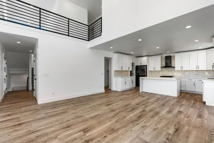 Open-concept design featuring wood-finish flooring and soaring ceilings