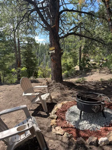 Outdoor fire pit area with natural rock border and decorative gravel