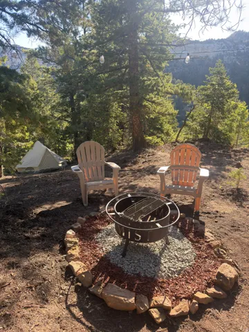 Fire pit with stone border, decorative gravel, and wood chip accents