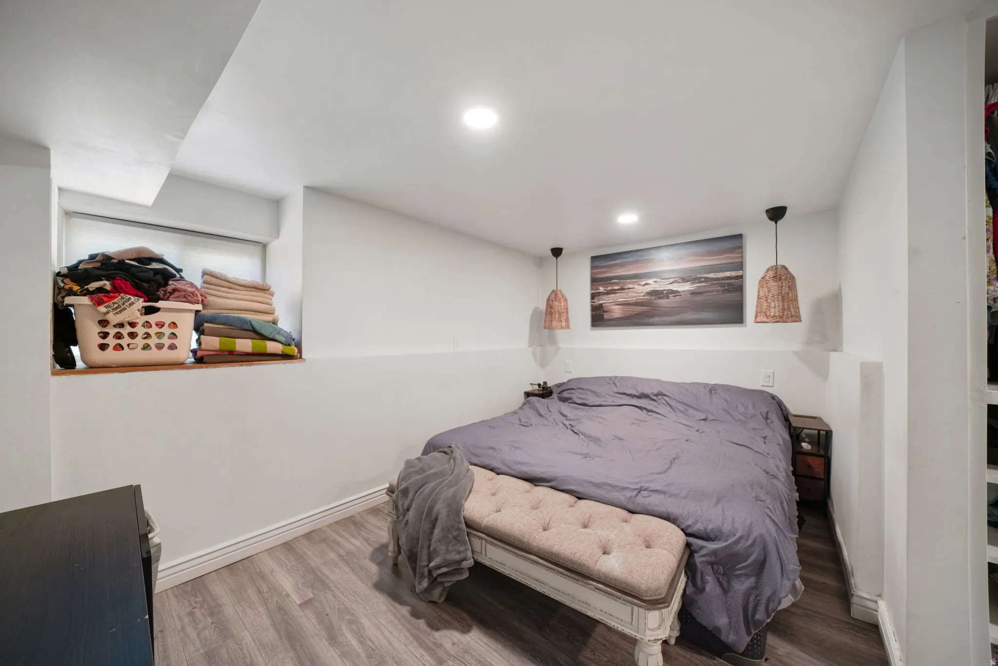 Recessed ceiling lighting, wood-finish flooring, and built-in closet shelving