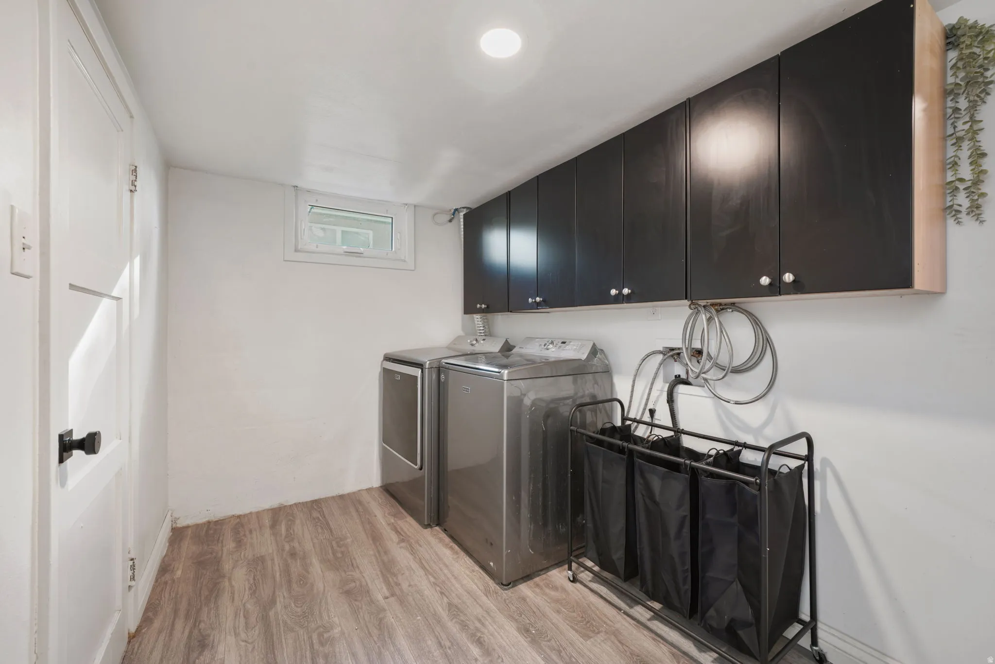 Wood-finish flooring, recessed ceiling lighting, and a window for natural light