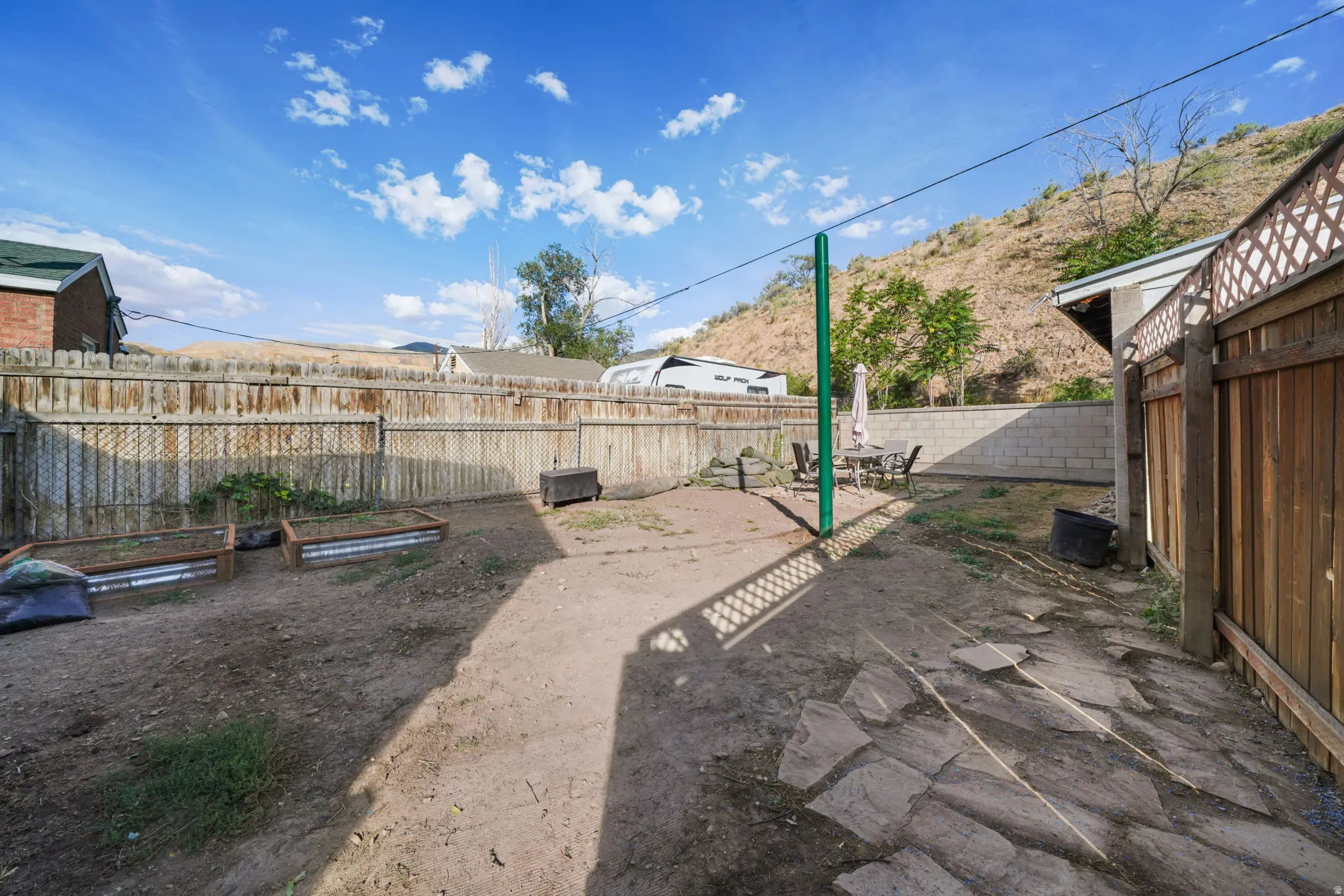Private backyard featuring wood fencing and a concrete block wall