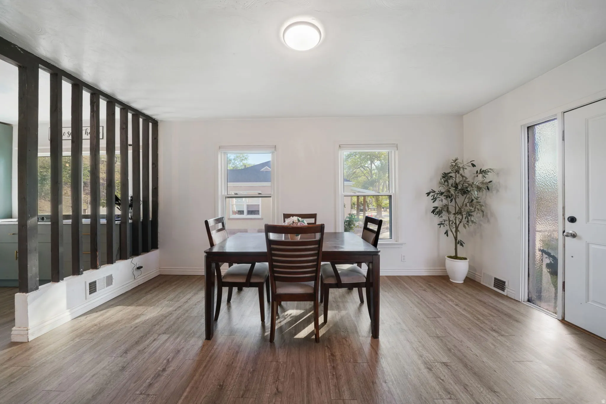 Wood-finish flooring, white walls, and a semi-open partition
