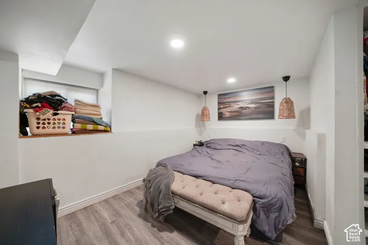 Recessed ceiling lighting, wood-finish flooring, and built-in closet shelving