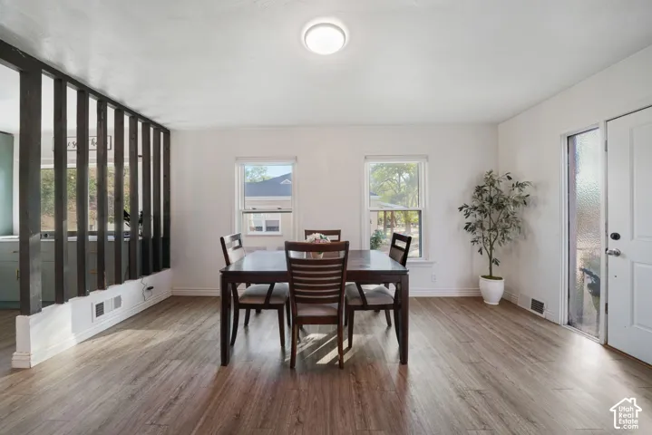 Wood-finish flooring, white walls, and a semi-open partition