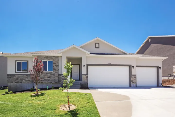 Stucco and stone veneer exterior with a covered entry