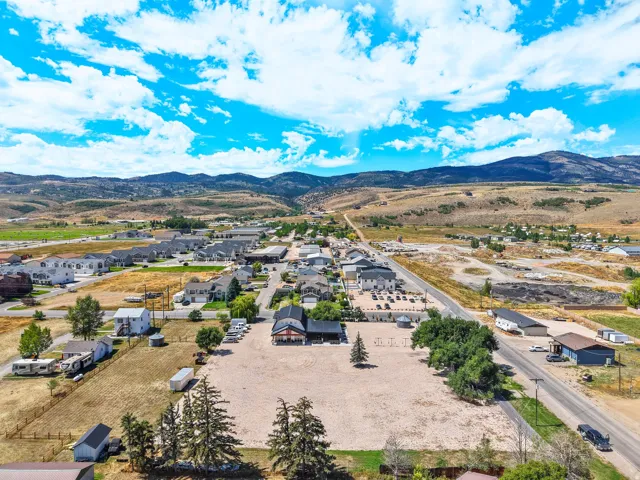 Expansive undeveloped lot with surrounding mature trees and mountain backdrop