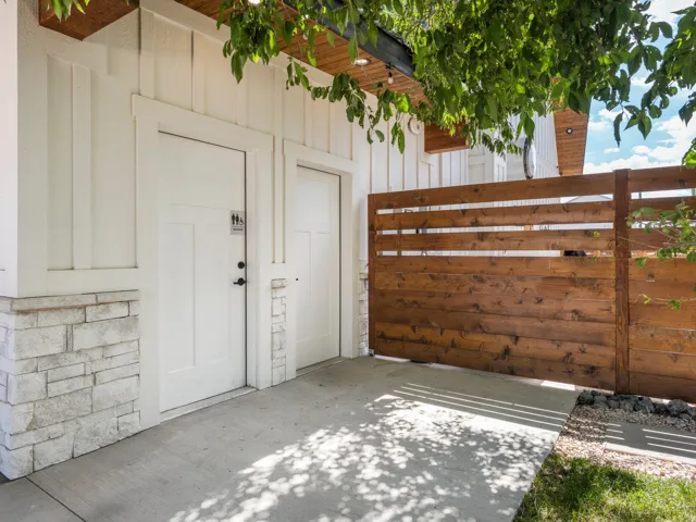 White board-and-batten siding with stacked stone accents