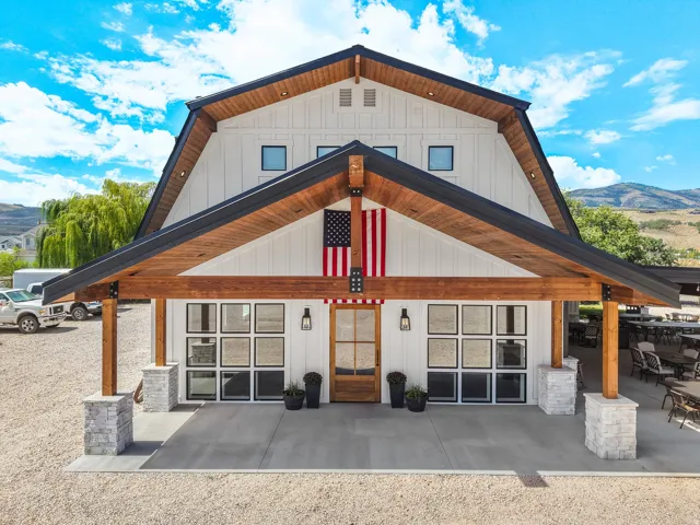 Modern barn-style architecture featuring a gambrel roof and board and batten siding