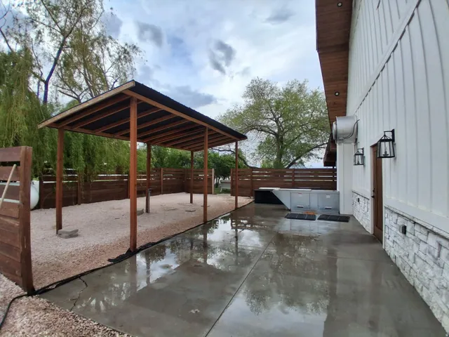 Concrete patio with a wood-clad privacy fence
