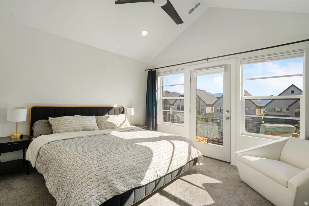 Vaulted ceilings with recessed lighting, ceiling fan, carpet flooring, and a private balcony
