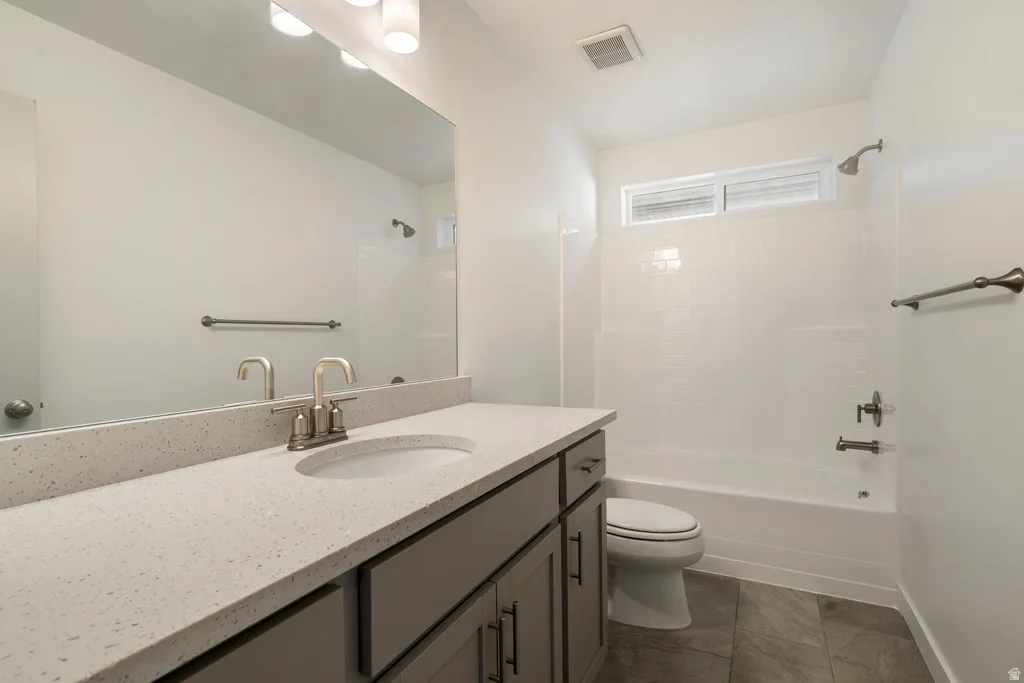 Spacious vanity with an undermount sink, a large wall mirror, and modern cabinetry