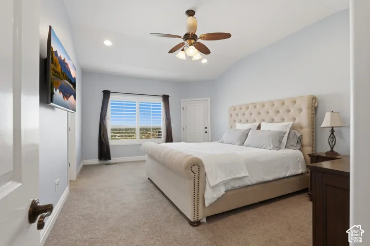 Vaulted ceiling featuring a central multi-light ceiling fan and recessed lighting, paired with interior shutters on a multi-pane window