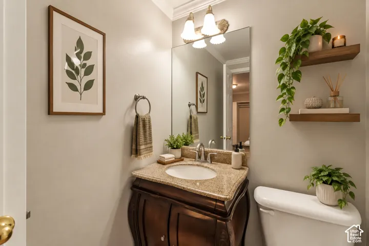 Vanity with a granite-style countertop, undermount sink, and polished chrome faucet