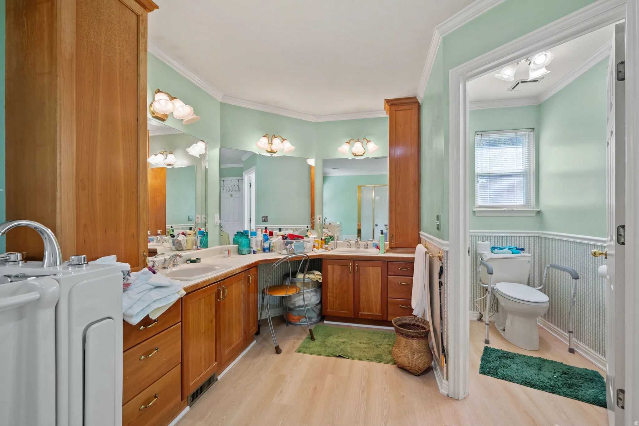Double vanity with wood-finish cabinetry and integrated sinks