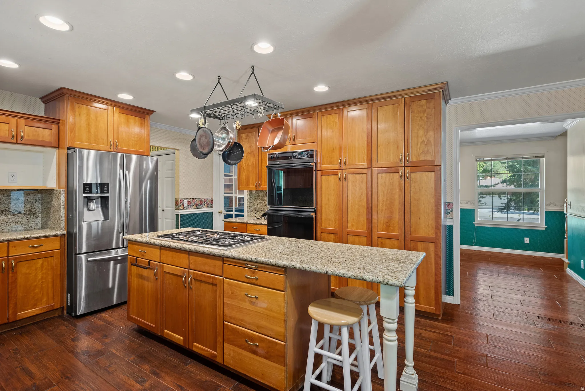 Kitchen featuring wood-finish flooring, recessed lighting, and extensive cabinetry