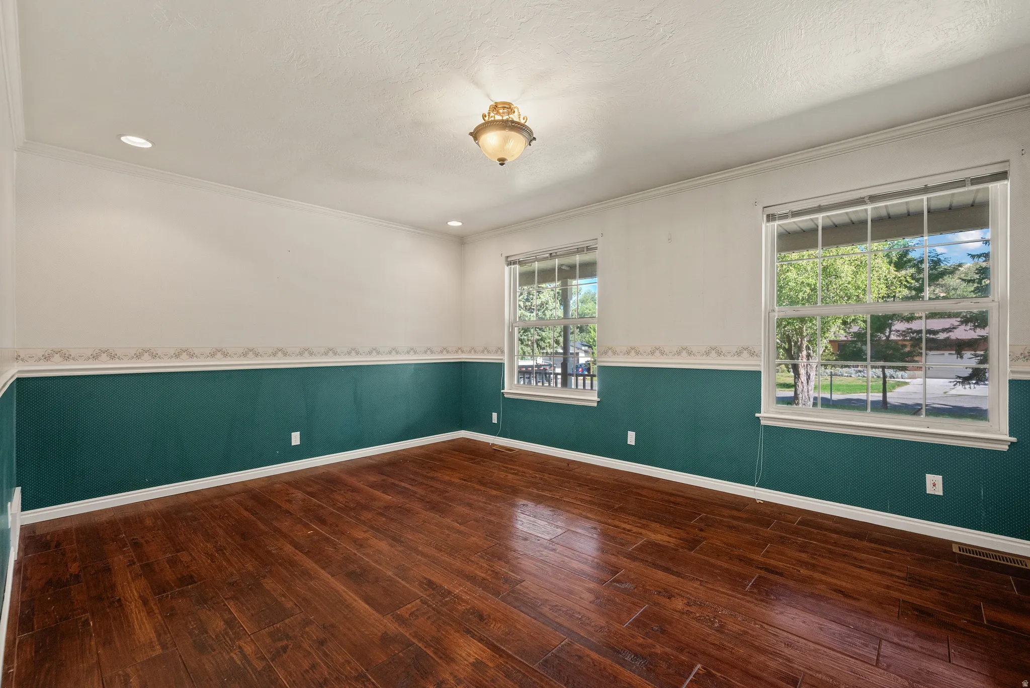 Rich wood-finish flooring complemented by a two-tone wall treatment
