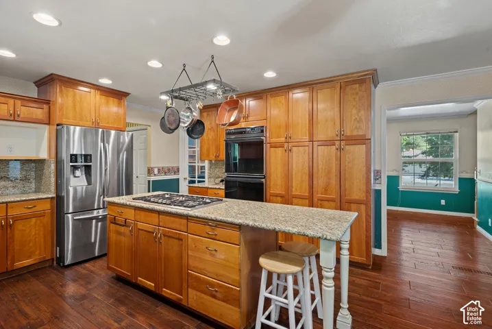 Kitchen featuring wood-finish flooring, recessed lighting, and extensive cabinetry
