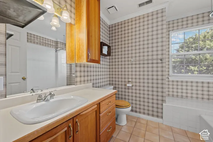 Wood-finish vanity with an integrated sink, polished chrome faucet, and overhead wood-finish cabinetry