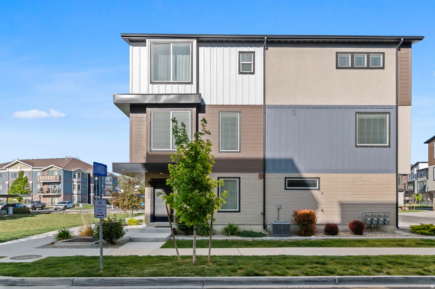 Contemporary exterior with multi-toned siding, stucco, and brick accents