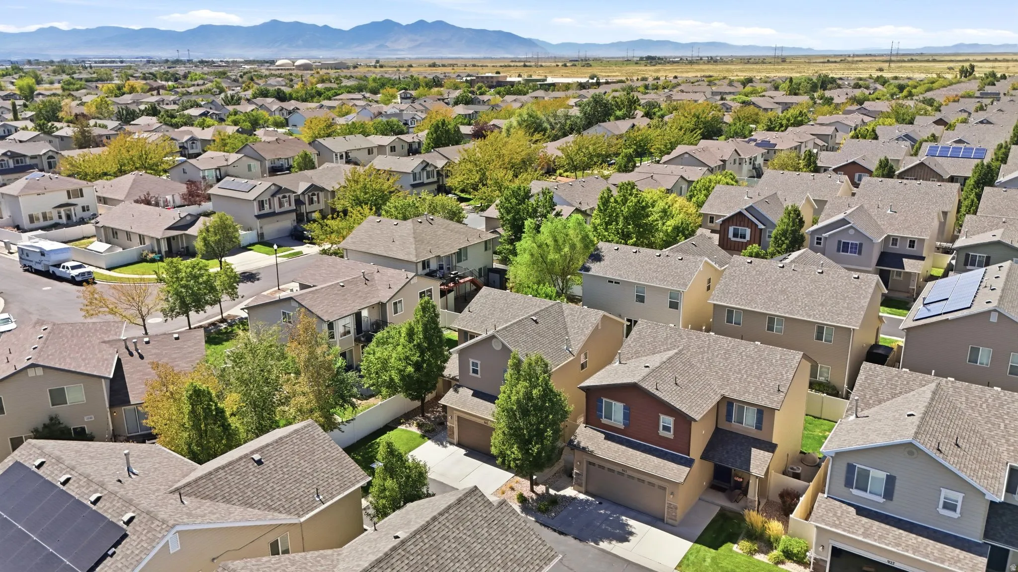 Residential neighborhood with established landscaping and mountain backdrop
