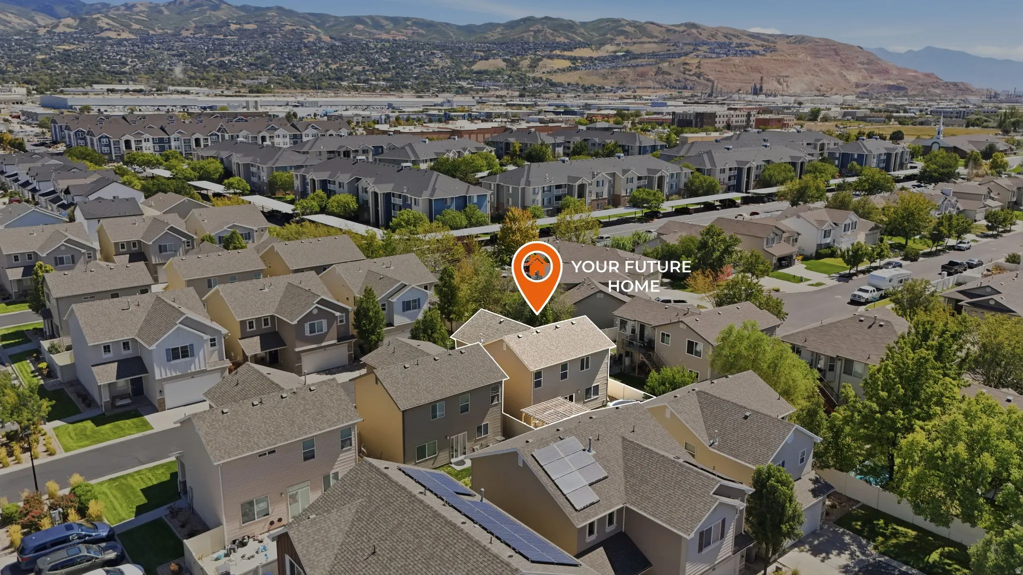 Residential neighborhood with multiple two-story homes and mountainous terrain in the background