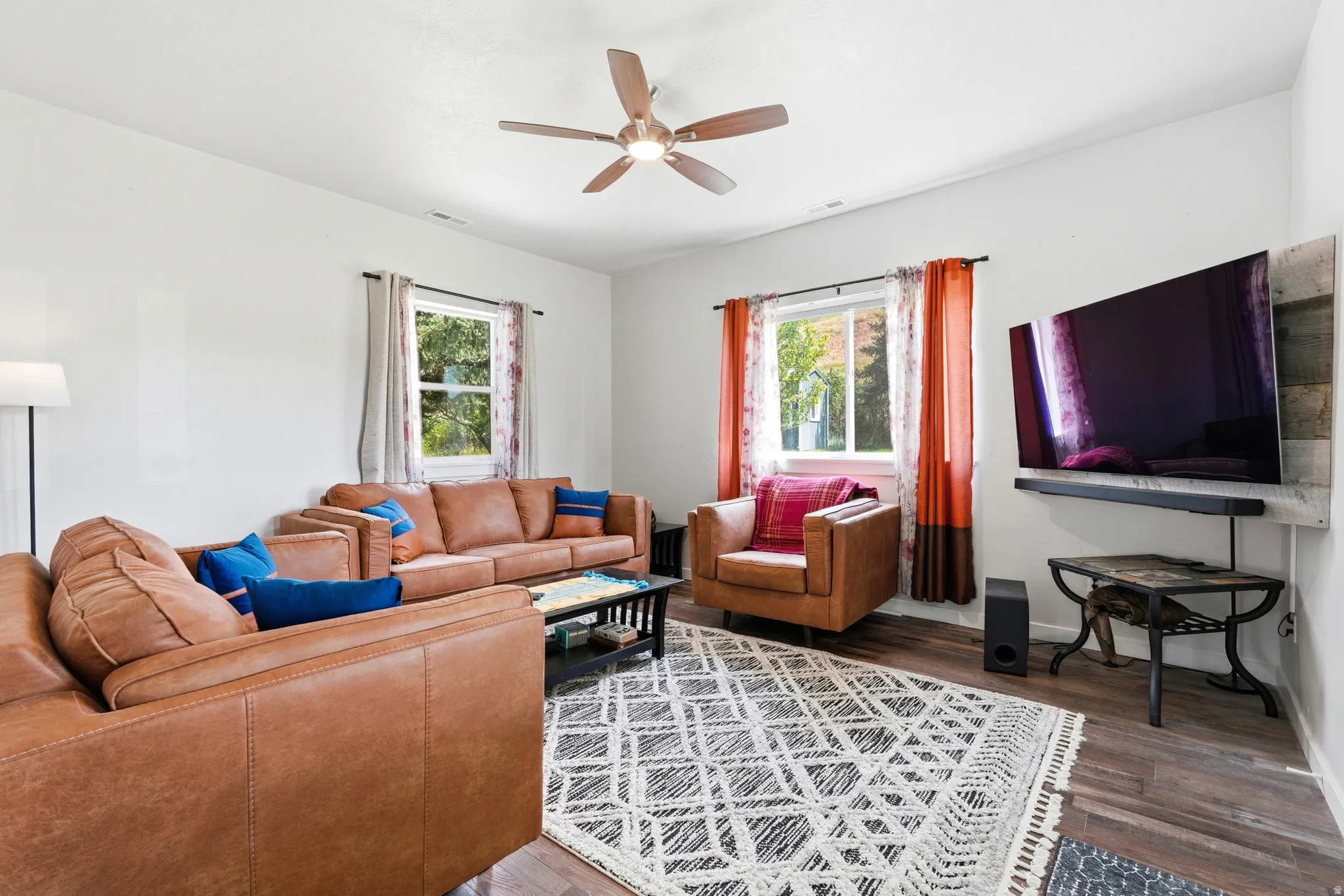 Recessed lighting, wood-finish flooring, and a ceiling fan with integrated lighting