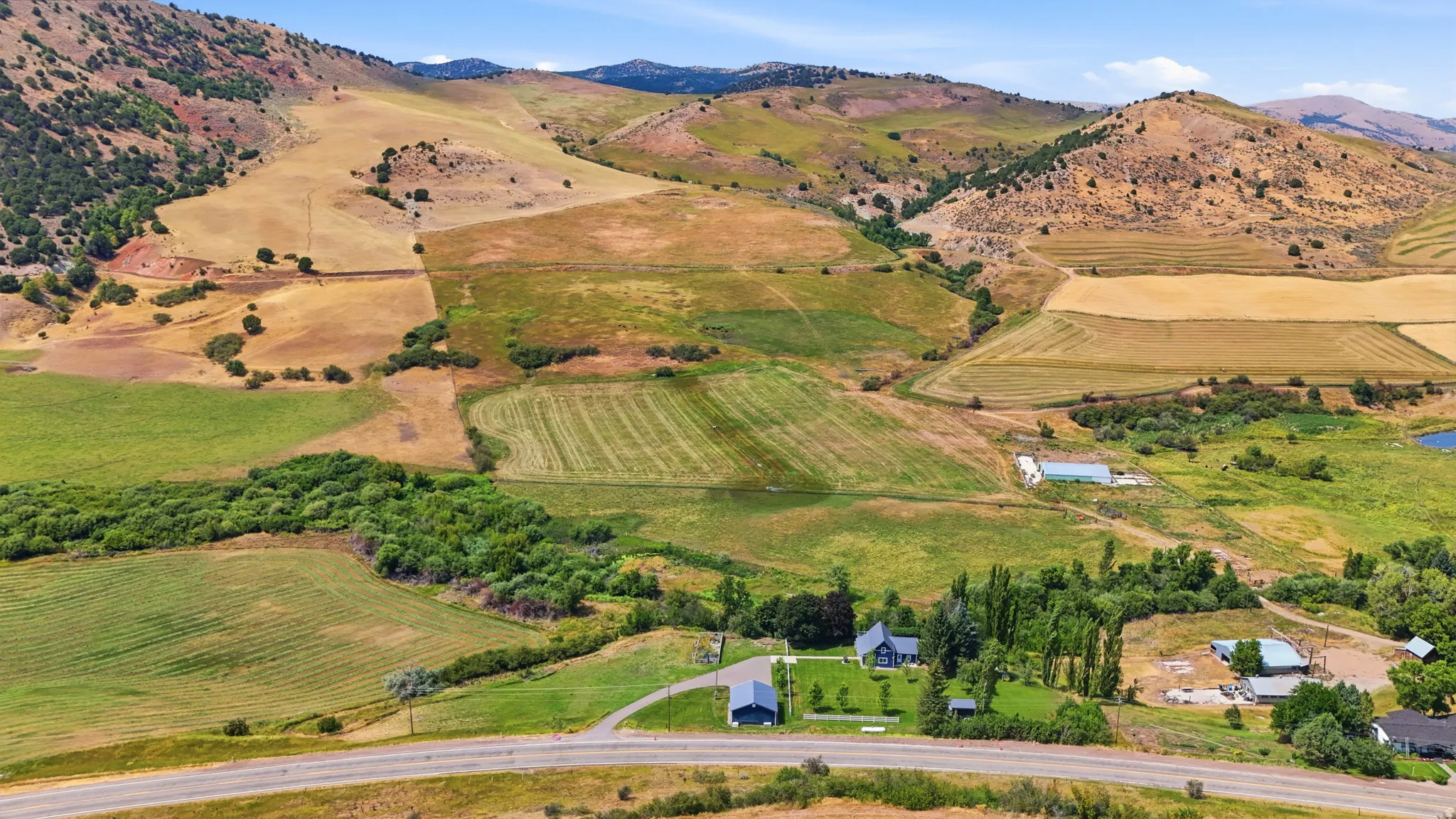 Expansive natural landscape with rolling hills and cultivated fields