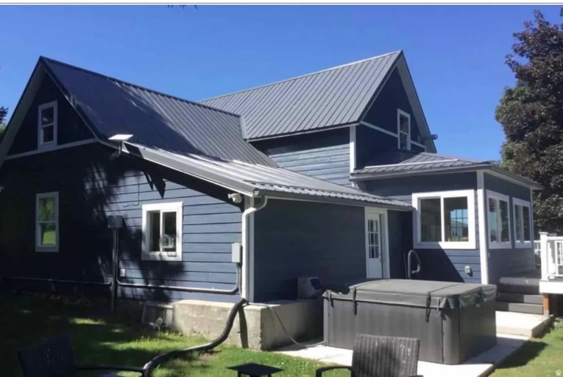 Dark blue horizontal siding exterior with white trim