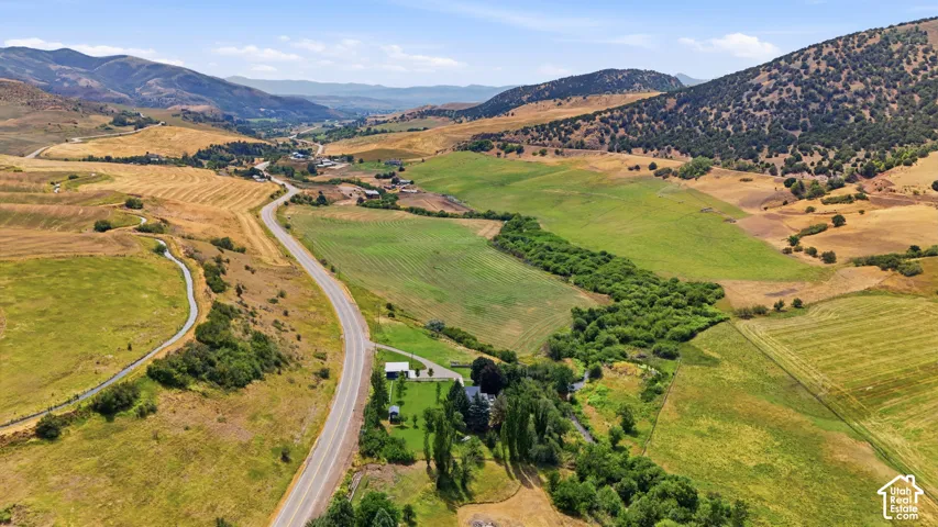 Expansive landscape featuring rolling hills and green fields