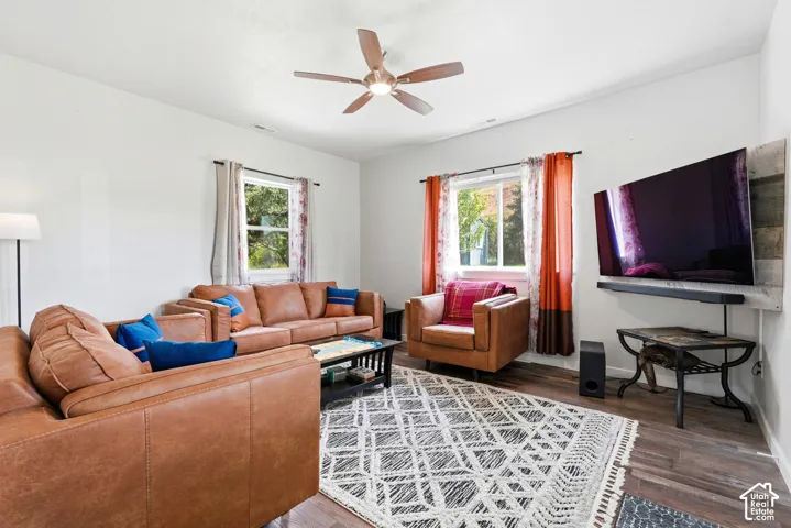 Recessed lighting, wood-finish flooring, and a ceiling fan with integrated lighting