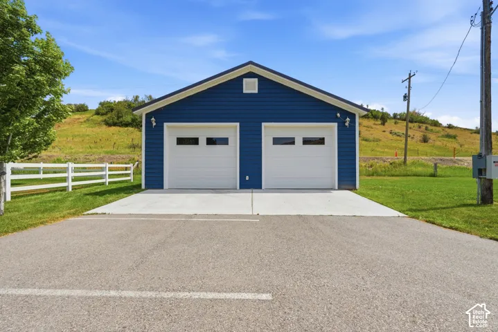 Detached two-car garage with blue siding and white trim