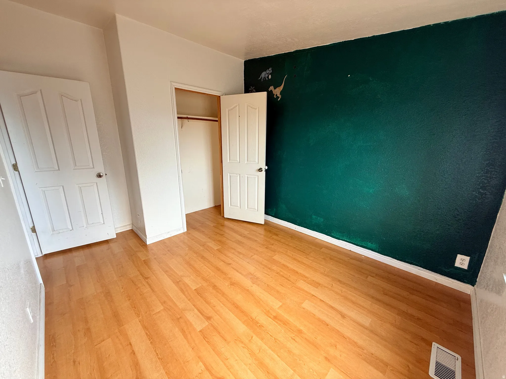 Wood-finish flooring with a contrasting dark accent wall