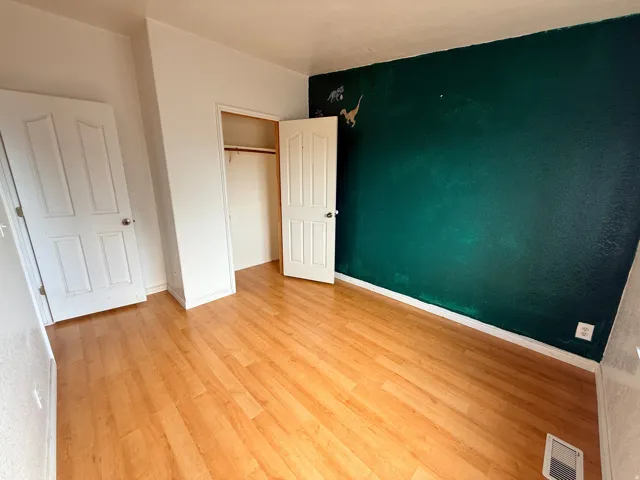 Wood-finish flooring with a contrasting dark accent wall