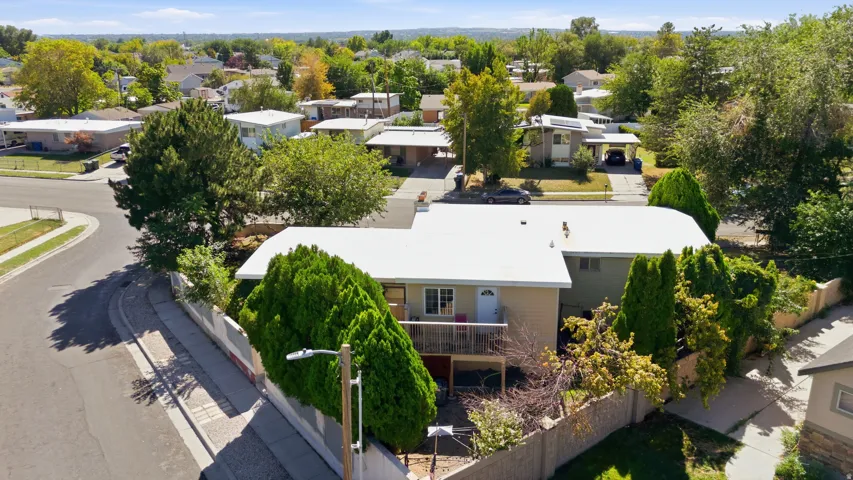 Residential property with a light-colored exterior and a white roof