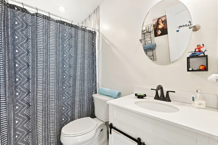 White vanity with a white countertop and integrated sink