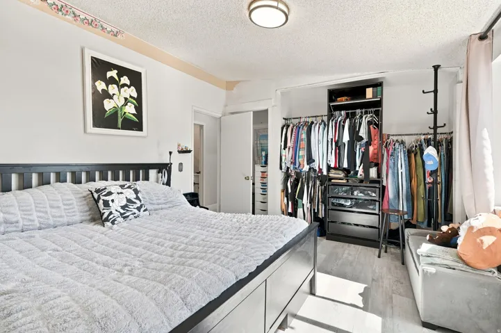 Recessed ceiling light fixture, wood-finish flooring, built-in shelving, and open wardrobe system